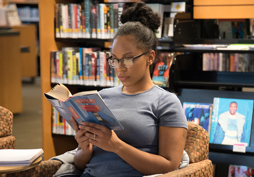 Person reading a book.