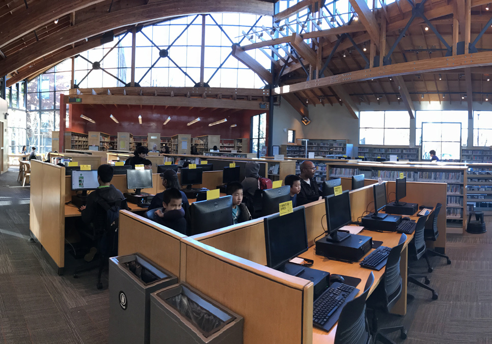 Library patrons in the public computer area at the Beacon Hill Branch