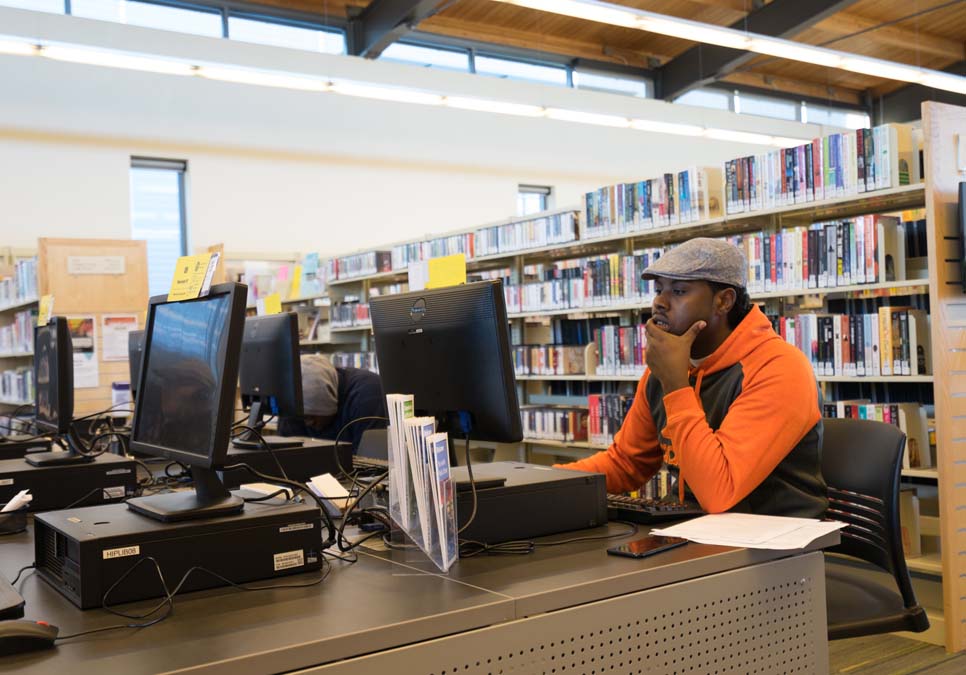 Library patron using public computer at the High Point Branch