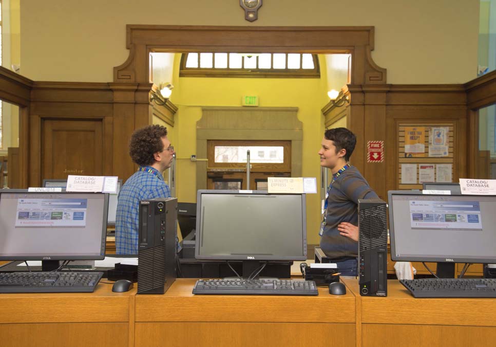 Library staff at service desk area at the University Branch