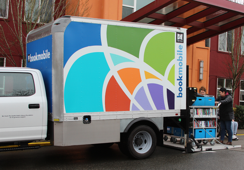 library staff helping patron in the bookmobile