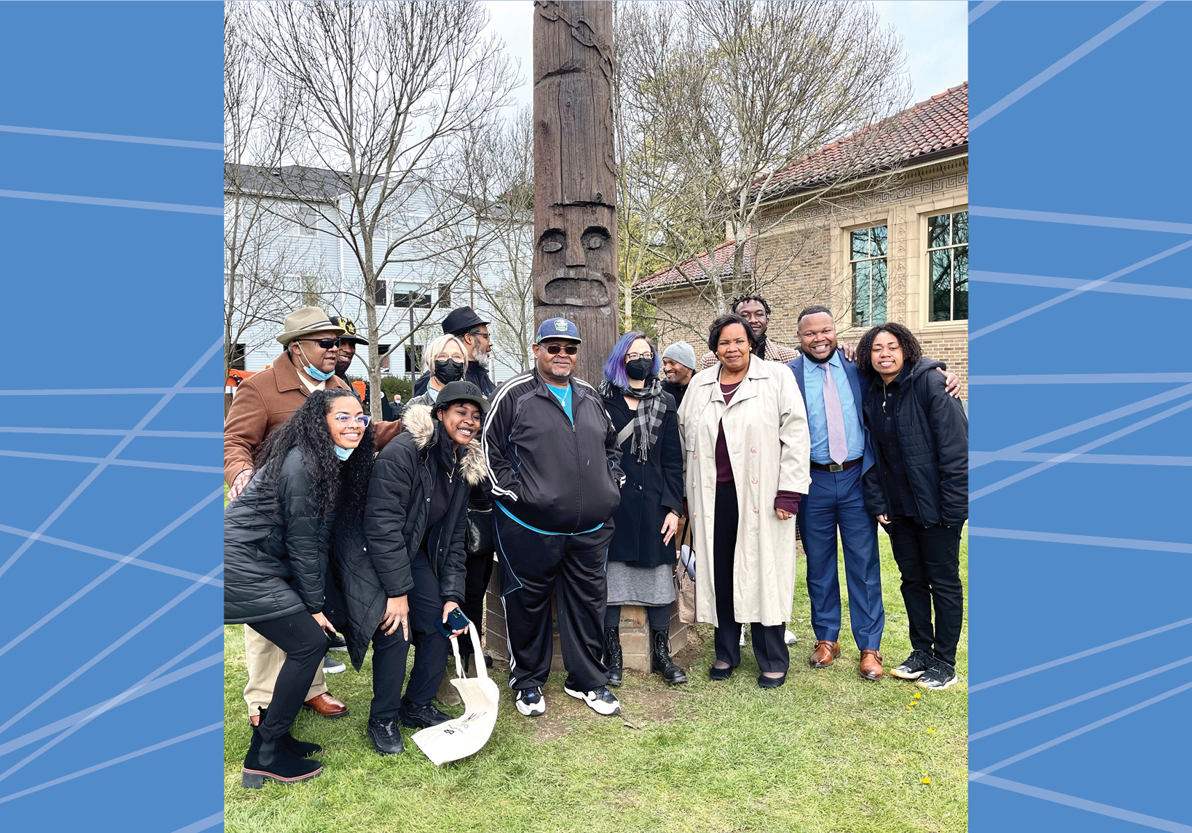 Group of people standing in front of Soul Pole.