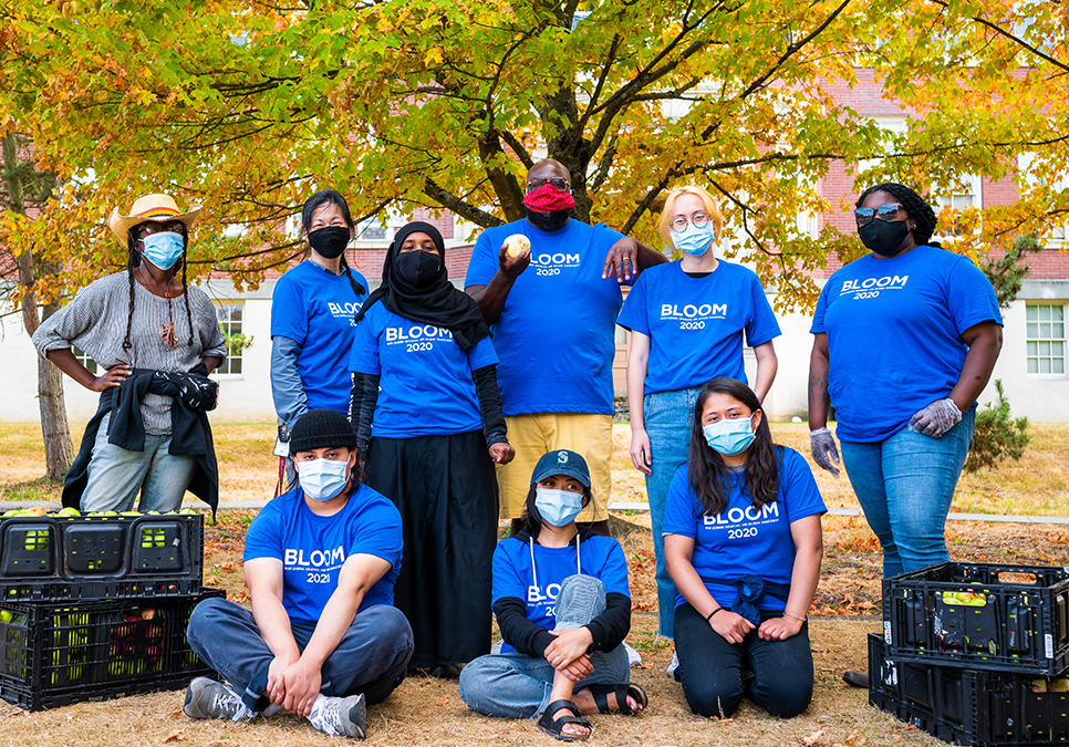 Masked participants posing with crates of apples. BLOOM cider press in Jimi Hendrix Park, 2020. Photo courtesy of Dancing in the Rain. 