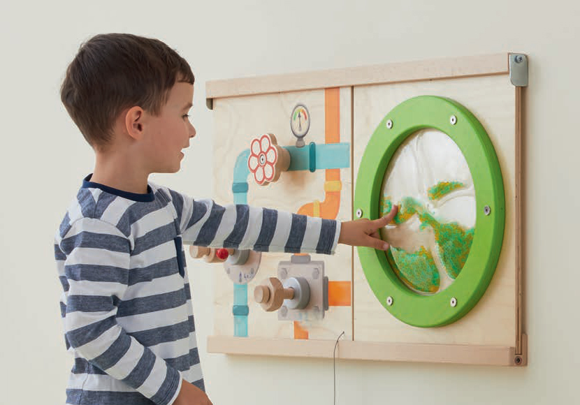 Child interacting with sensory wall